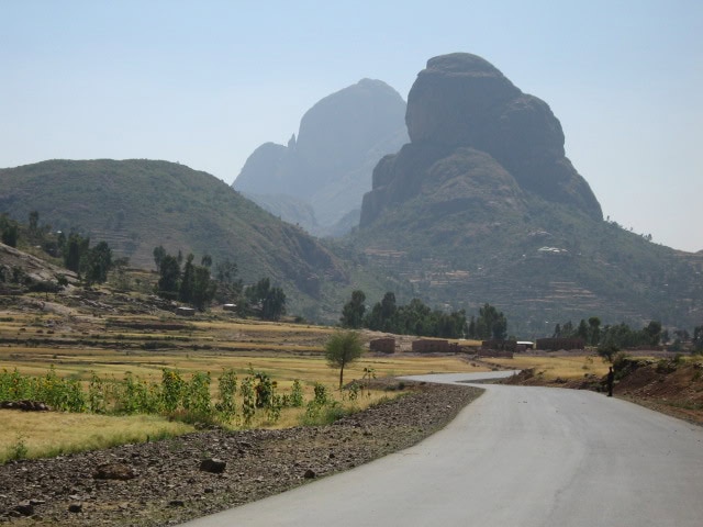 Photo of Ethiopian landscape with a winding round heading towards a mountain