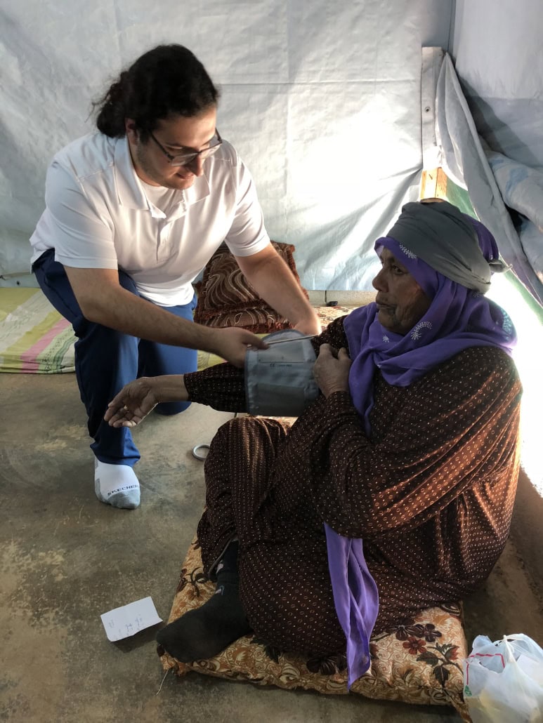 Iasis giving aid to civilian